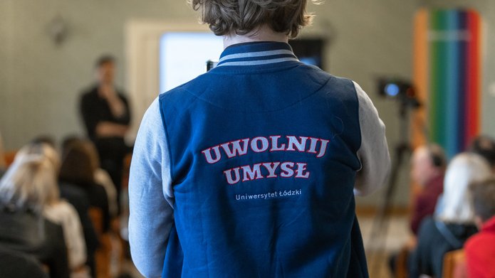 a person wearing a jacket with the "Free your Mind" slogan