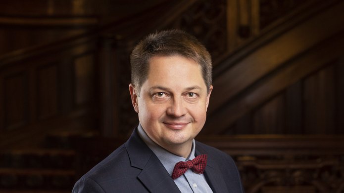 an elegantly dressed man who is wearing a bowtie