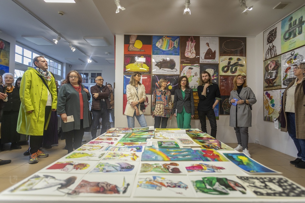 zebranie goście na wernisażu wśród plakatów