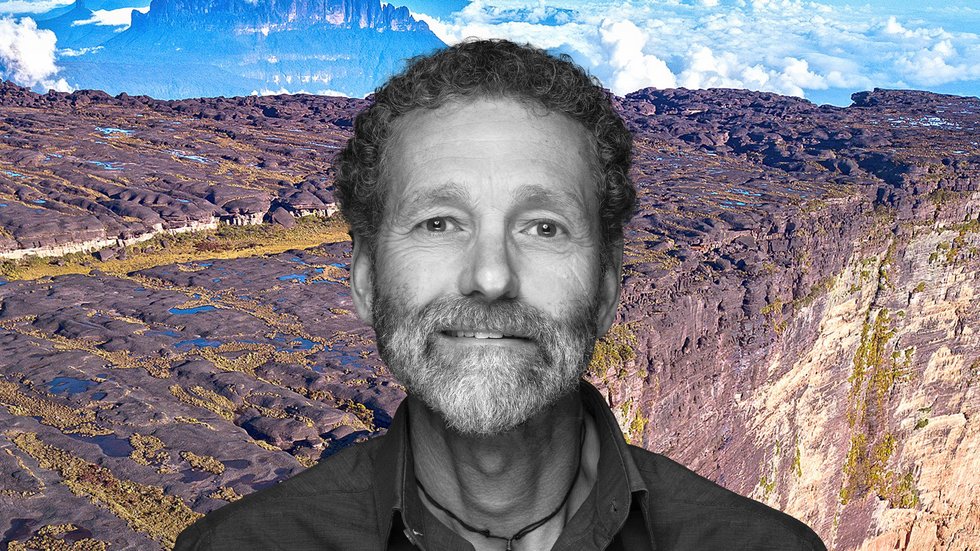 Dr Philippe Kok against the background of a monumental plateau rising out from the jungle