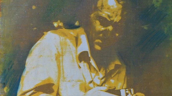 a photo showing a man leaning over a camera