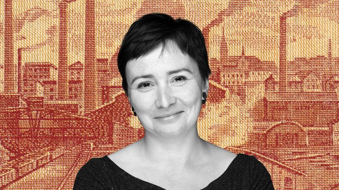 Dr Agata Zysiak against the background of a panorama of nineteenth-century Lodz printed on orange textile material