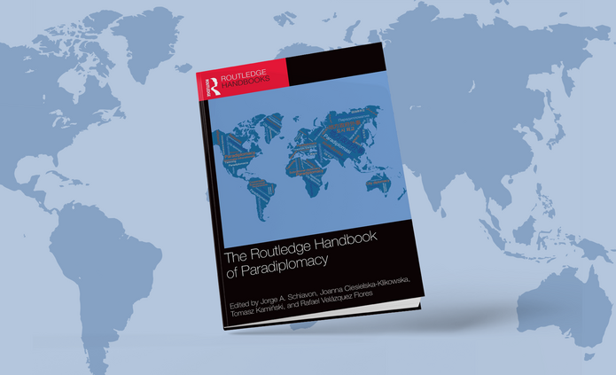 cover of the publication in question against the background of a world map