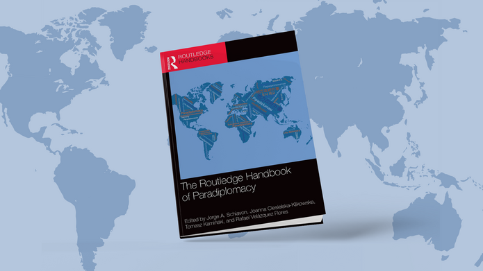 cover of the publication in question against the background of a world map