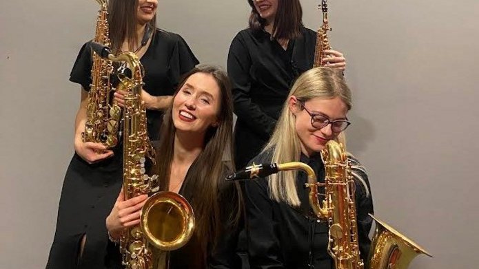 Four artists from the Sombrero Sax Quartet with instruments 