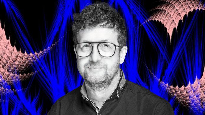 Prof. Dariusz Wardowski on a colorful background with fractals