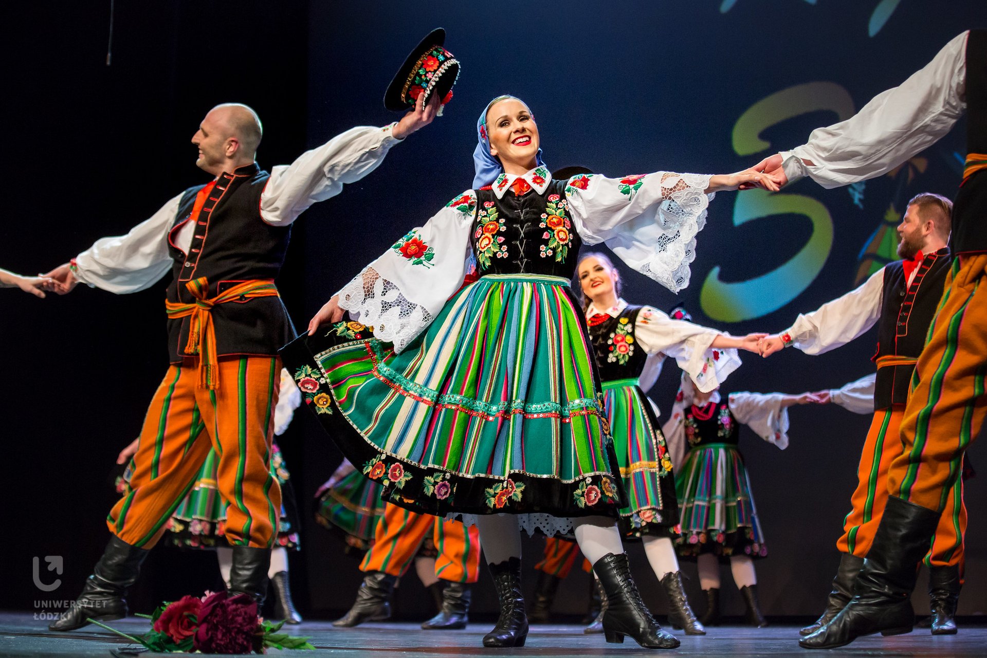 The Academic Song and Dance Ensemble of the University of Lodz "KUJON" – dancers in folk costumes, dancing on the stage