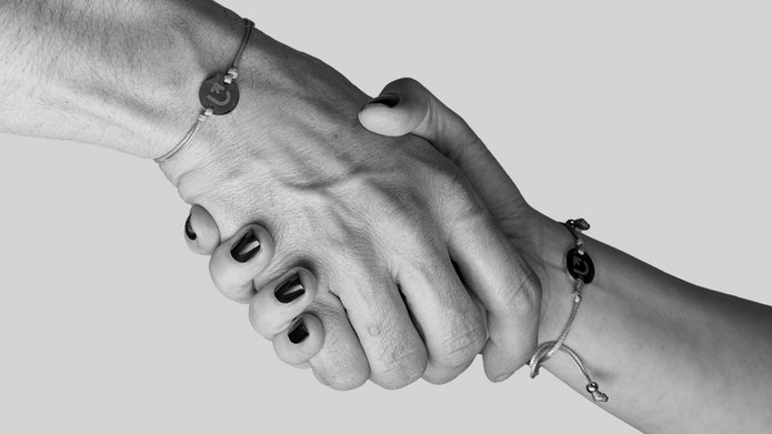 two hands holding each other