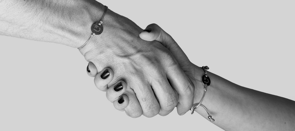 two hands holding each other