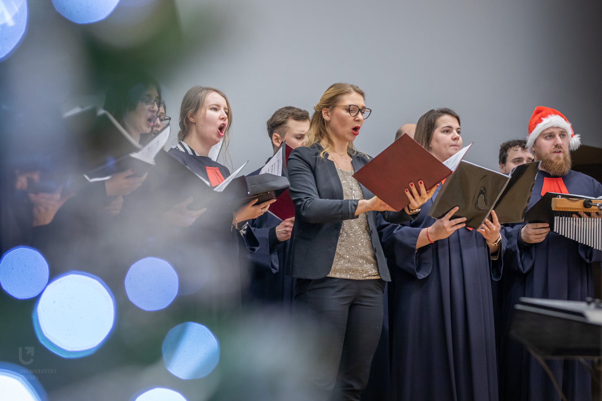 The University of Lodz Choir – women and men singing, holding sheet music 