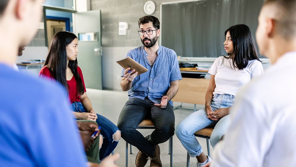 a decorative element: a person conducting classes with students