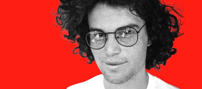 Face of a young man wearing glasses