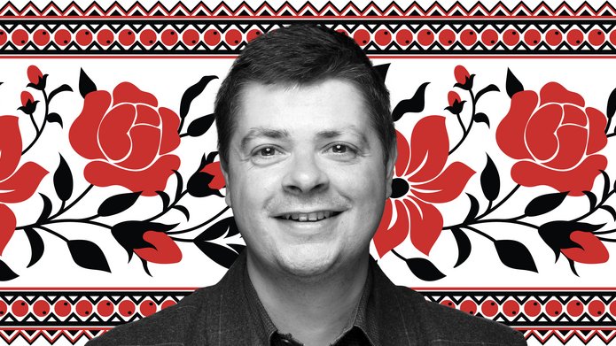 Dr Tomasz Lachowski on a white background with a pattern of red flowers with black leaves