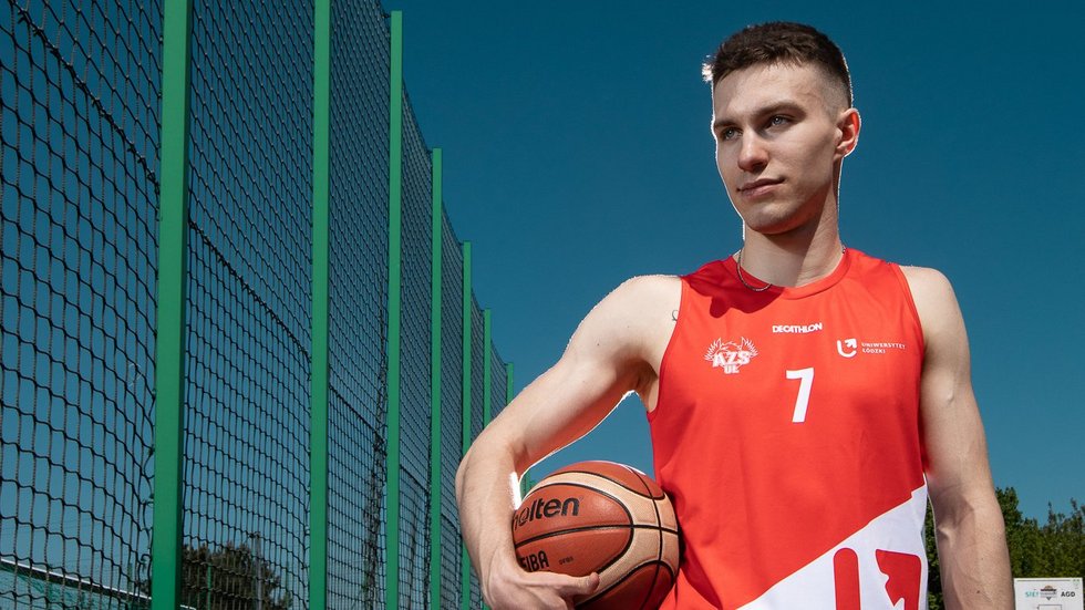 [Translate to English:] Chłopak z piłka na boisku do koszykówki