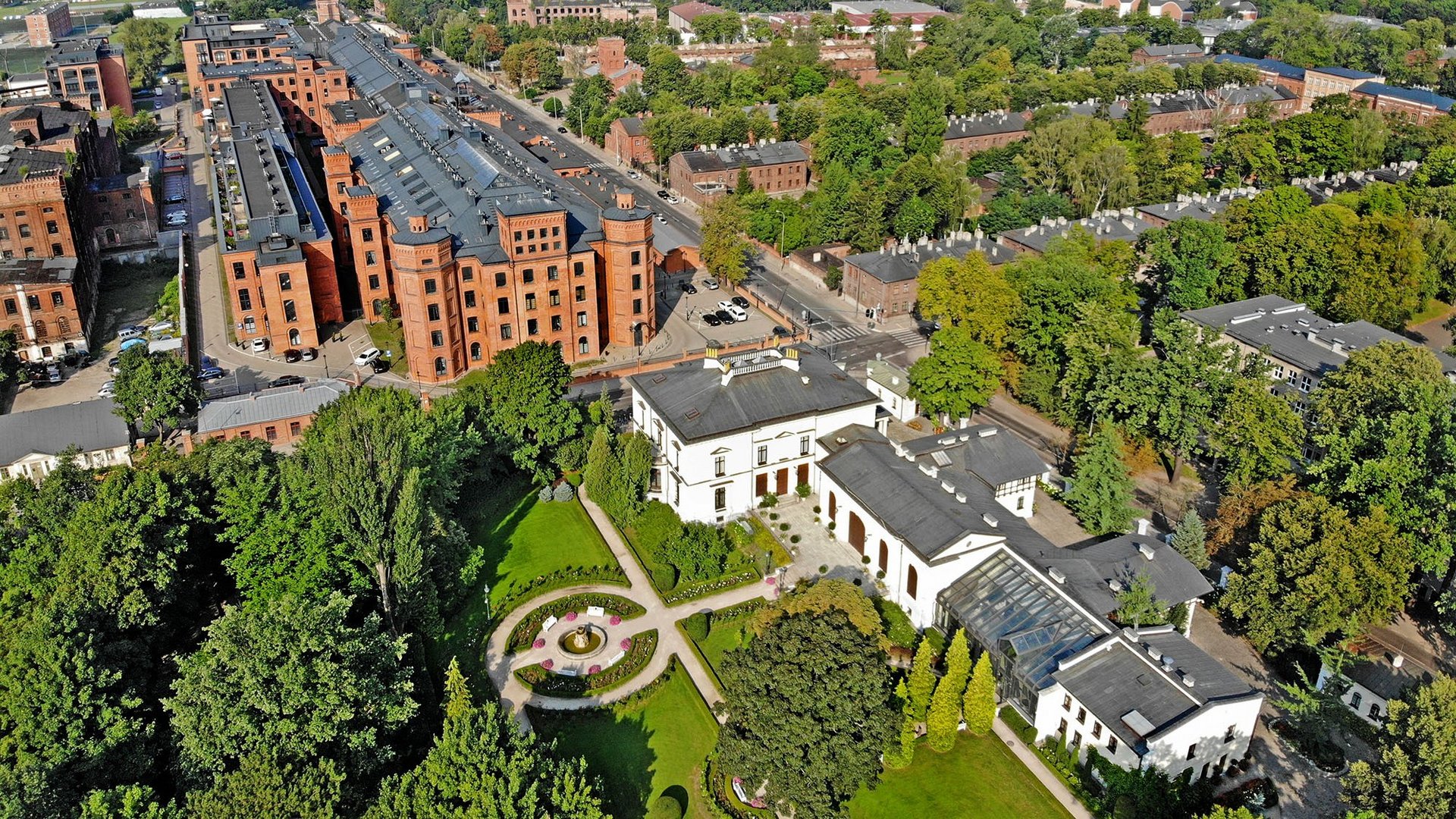 Lodz from a bird's eye view, with Herbst Palace and green areas in the frame