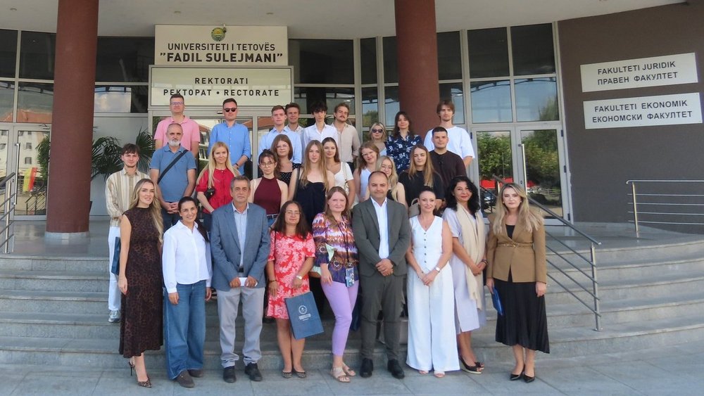 Students and academics in front of the university
