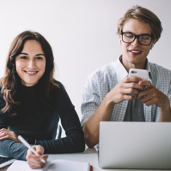 a decorative element: a smiling young woman and a man sitting at a desk
