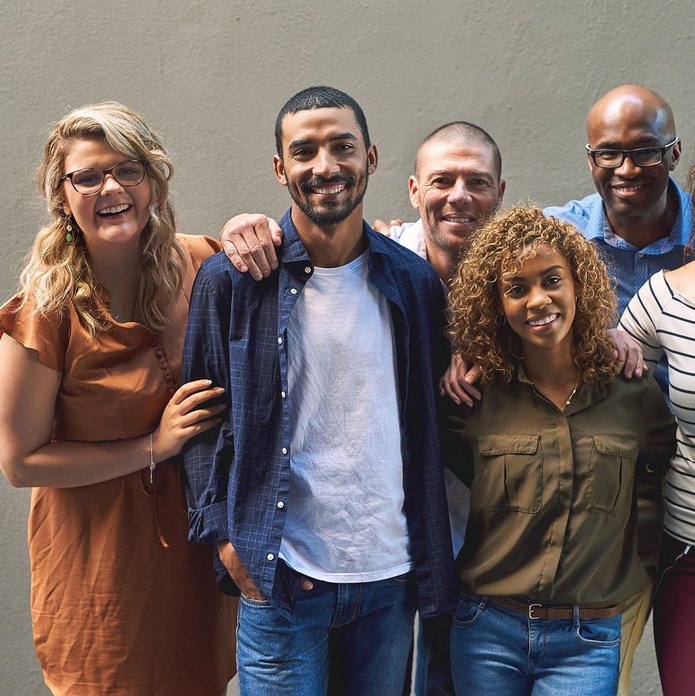 Shot of a group of cheerful friends standing together for a portrait while looking at the camera