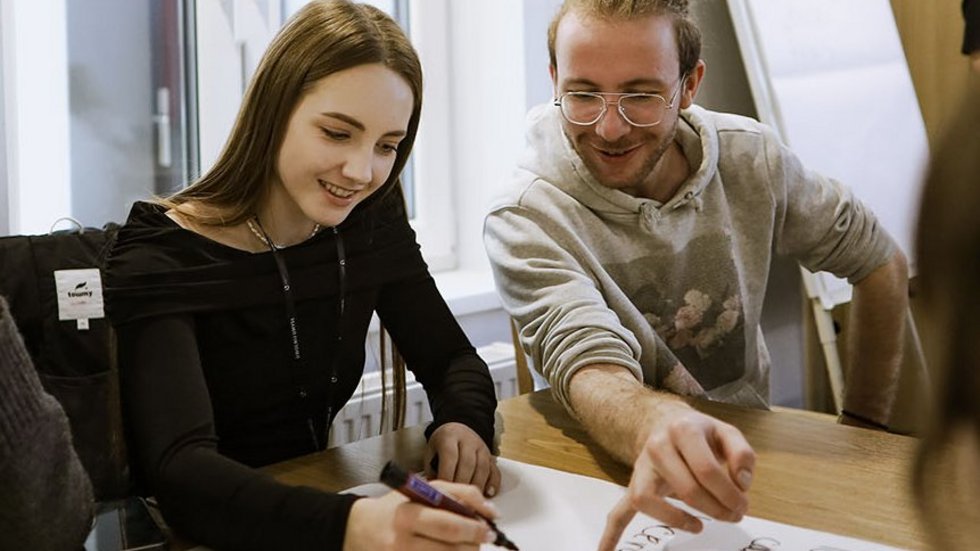 a decorative element: two young people working on something together