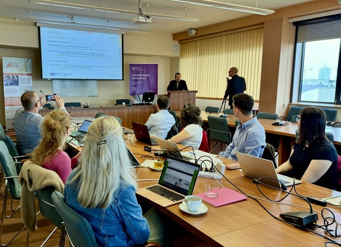 the meeting participants looking at the screen and listening to a lecture