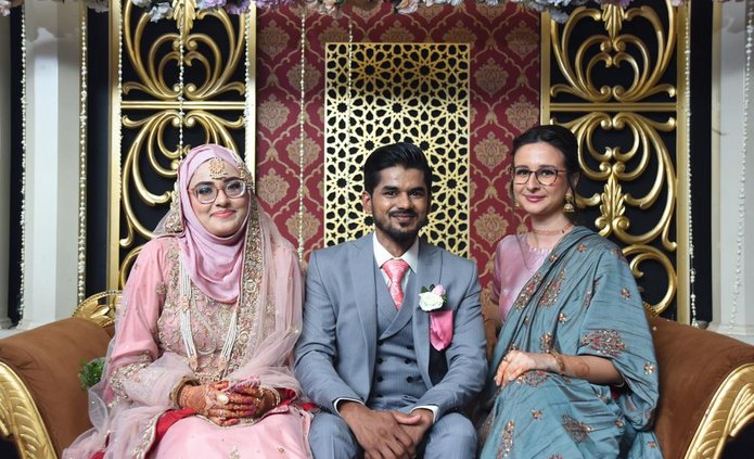 The student with the newly-weds during a wedding in Pakistan