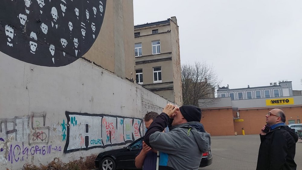 a visually impaired person viewing a mural by the use of a phone