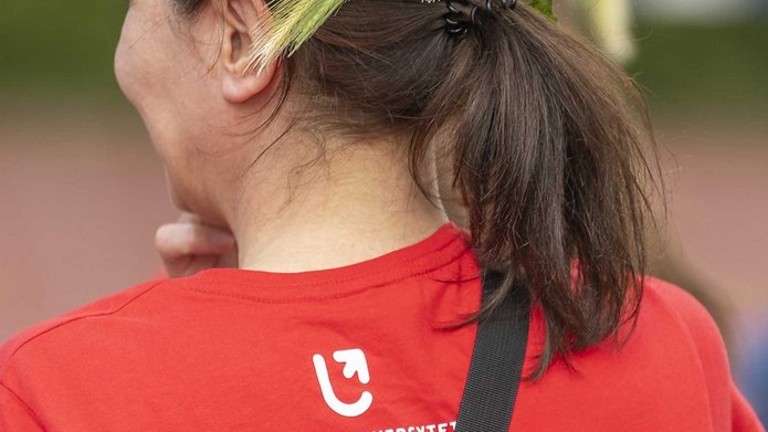 a decorative element: a woman in a wreath wearing a UniLodz T-shirt