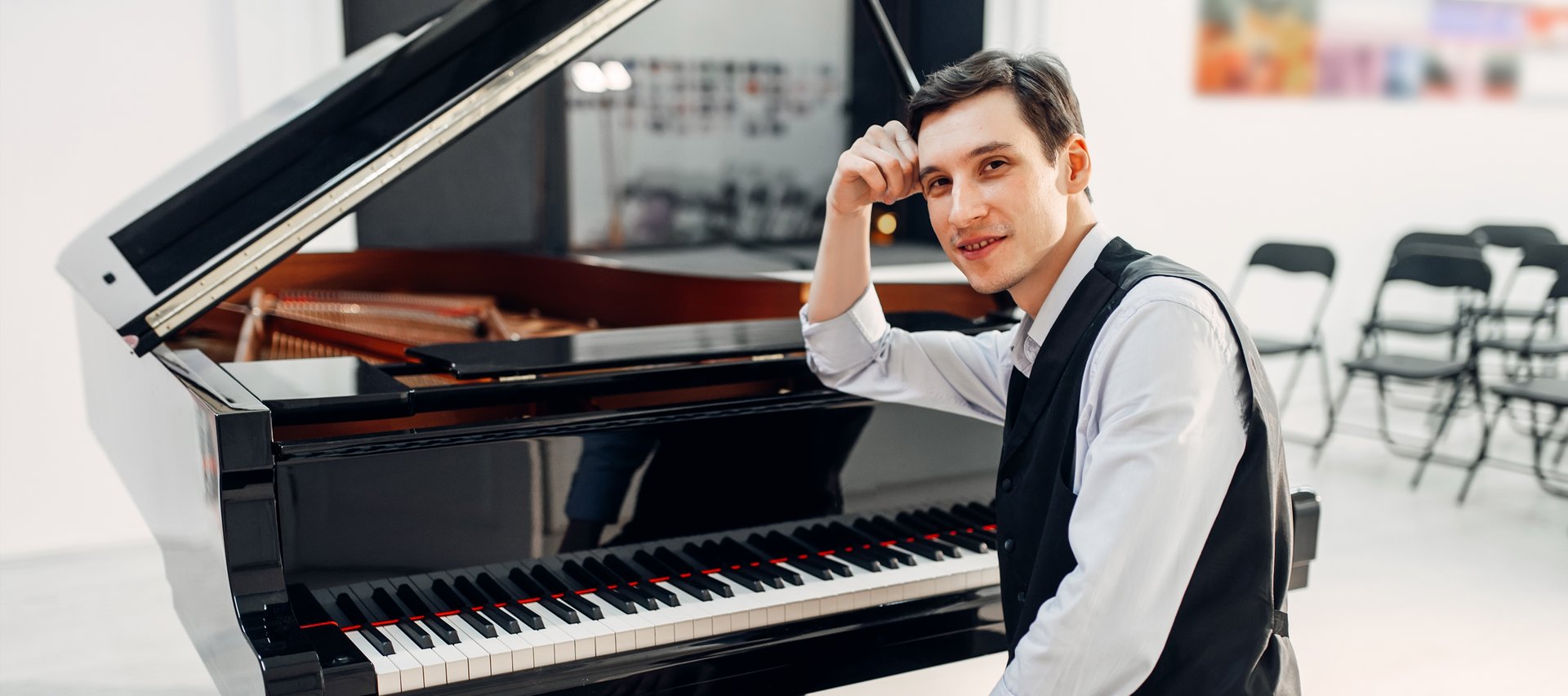A boy sitting at a piano