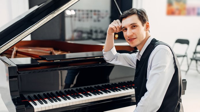 A boy sitting at a piano