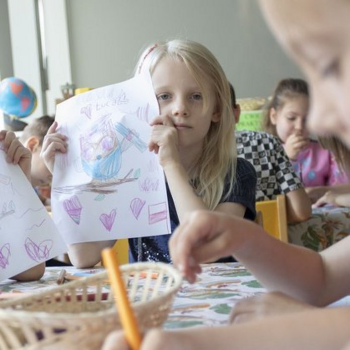 Children painting card designs for the University of Lodz campaign "Flowers? - No, thank you?"