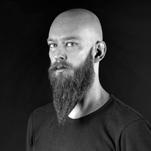 A black and white photograph of Maciej Andrzejewski, semi-profile