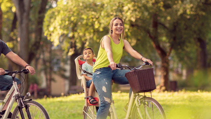 cyclists in the park: a woman, a man and a child