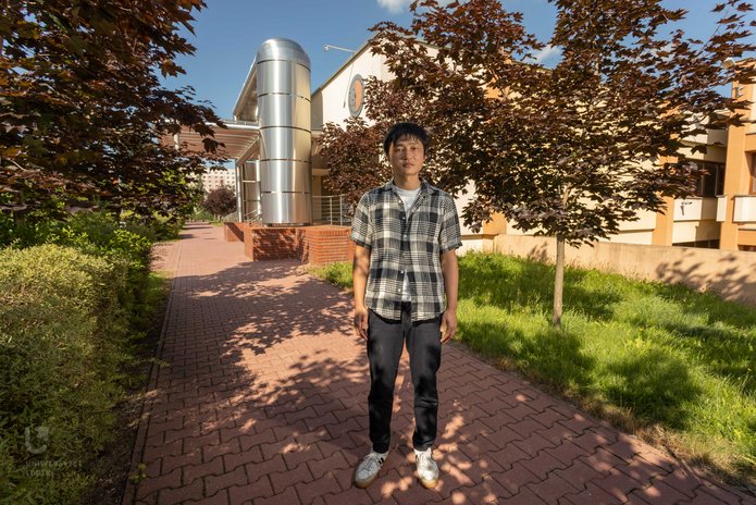 Kazuma Ishio in front of the Faculty of Physics and Applied Informatics, UL