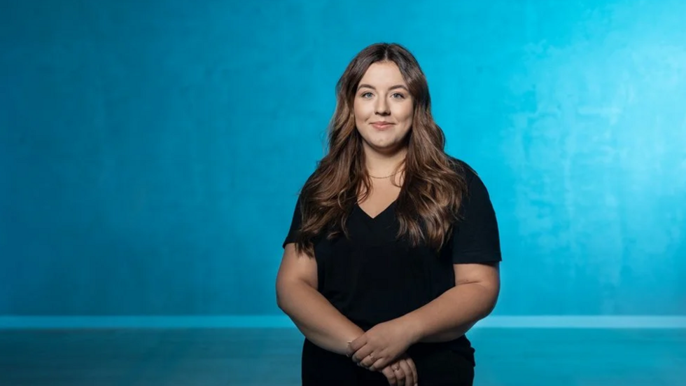 A UniLodz students smiles directly at the camera.