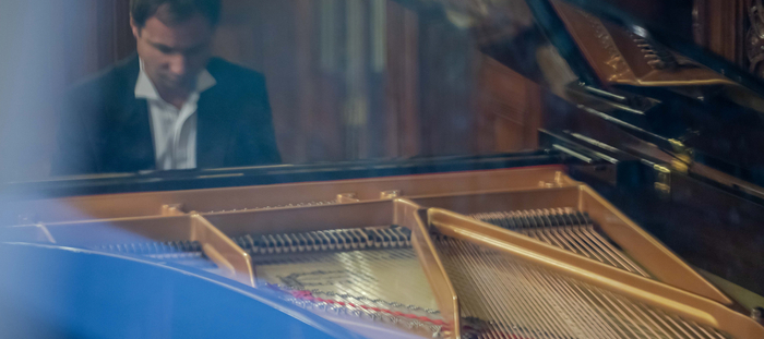 A man playing the grand piano