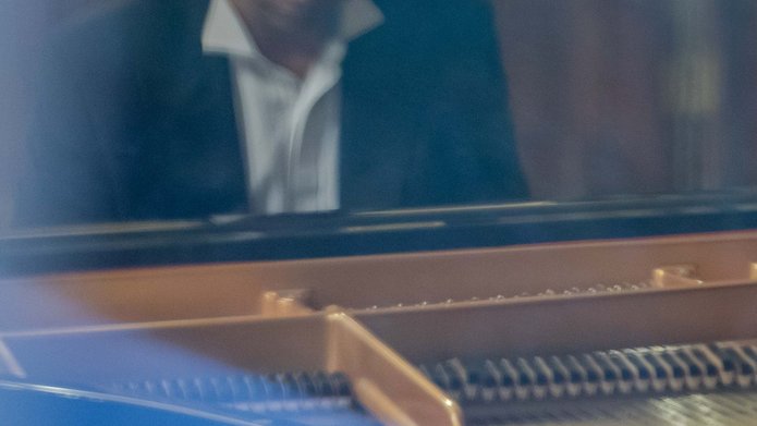 A man in a suit playing the piano