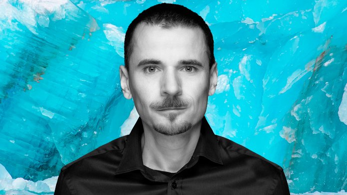 Prof. Krzysztof Pabis on the background of a uniform wall of glacial ice