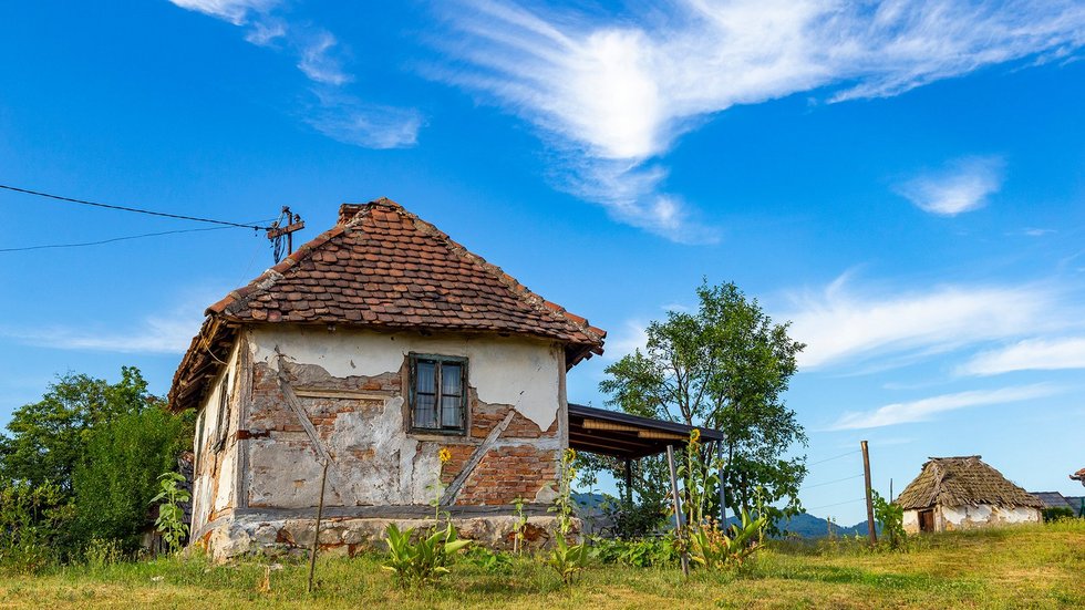 Old rural house in Serbia. Traditional Balkan countryside architecture.