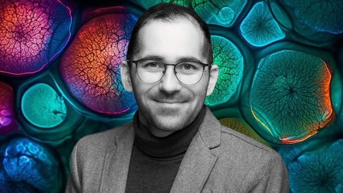 Dr Damian Jacenik on the background of a collage of colorful cells