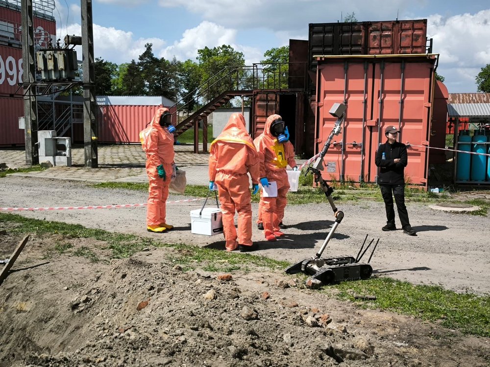 From 18–22 May, the Central School of the State Fire Service in Czestochowa, Poland, hosted an international training course on situation assessment and sampling in areas contaminated with Chemical, Biological, Radiological, and Nuclear (CBRN) agents. The course was organized by the Organisation for the Prohibition of Chemical Weapons (OPCW), recipient of the 2013 Nobel Peace Prize. Our Team Member, Maksymilian Stela, had a honors to be one of the trainers. The training brought together representatives from 18 States Parties to the Chemical Weapons Convention. They were representing military forces, fire and rescue services, police, and civil protection organizations from North and South America, Africa, and Asia. As CBRN threats continue to evolve amid growing geopolitical tensions and the persistent risk of terrorism, enhancing international preparedness and response capabilities remains a global priority. International collaboration, practical expertise, and readiness remain essential pillars of effective CBRN response. This goal is shared by the Biohazard Prevention Centre.