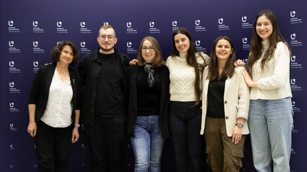 a photo of the entire project group in front of the faculty banner