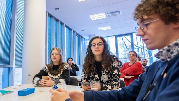 A decoartive element: a group of students working together at a desk