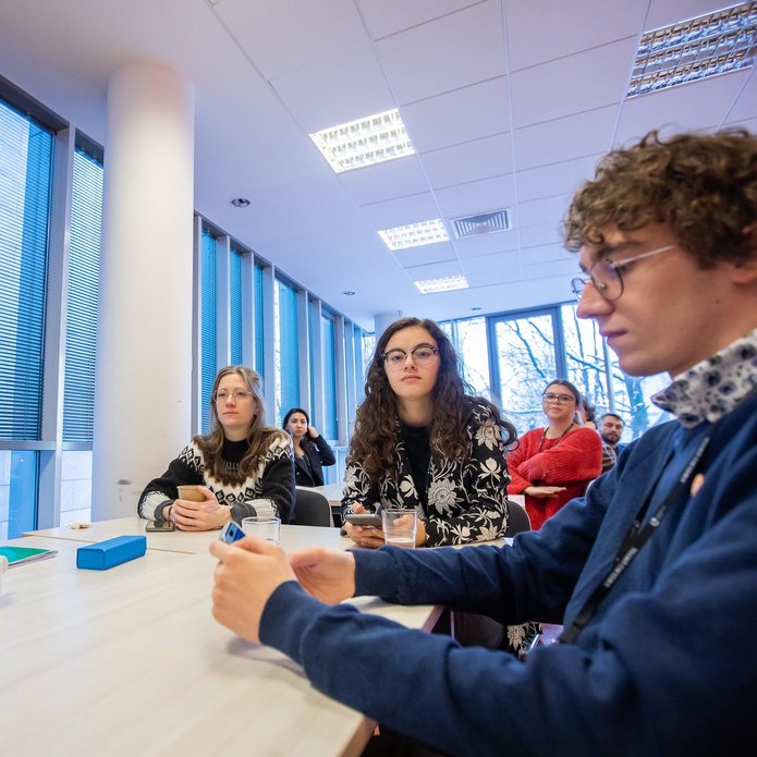 A decoartive element: a group of students working together at a desk