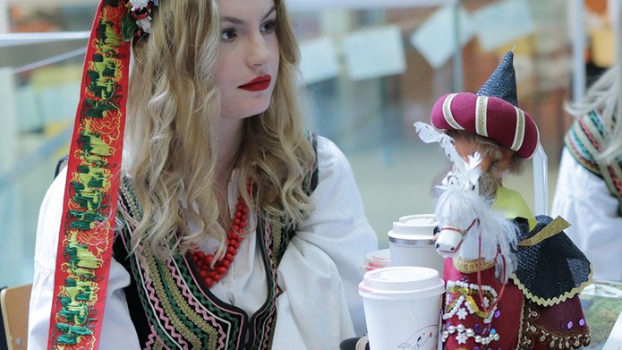 A girl wearing a national costume at the stand