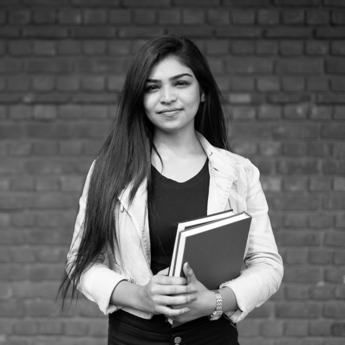 a black and white photo of a woman holding books