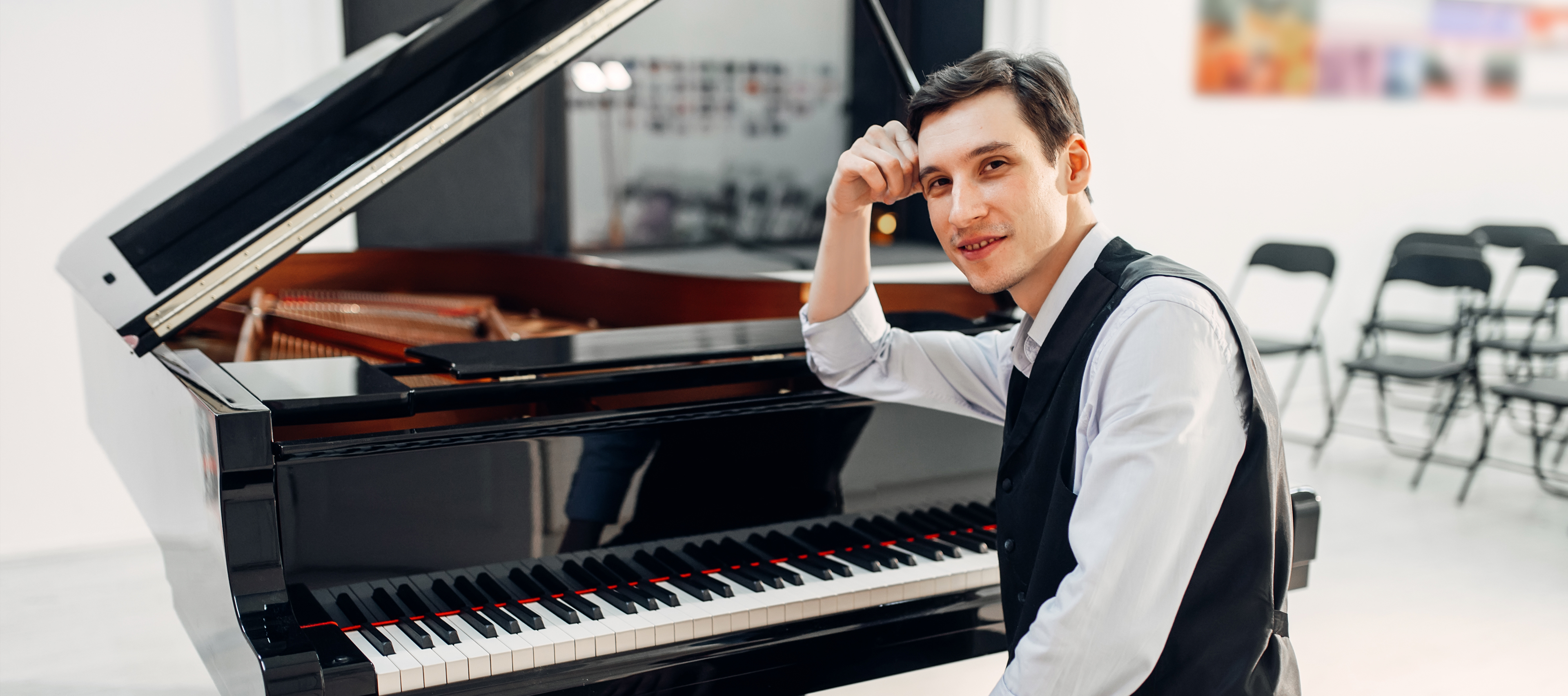 A boy sitting at a piano