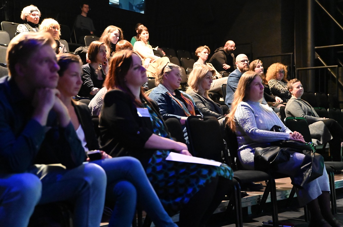 a dozen or so people are sitting in the audience