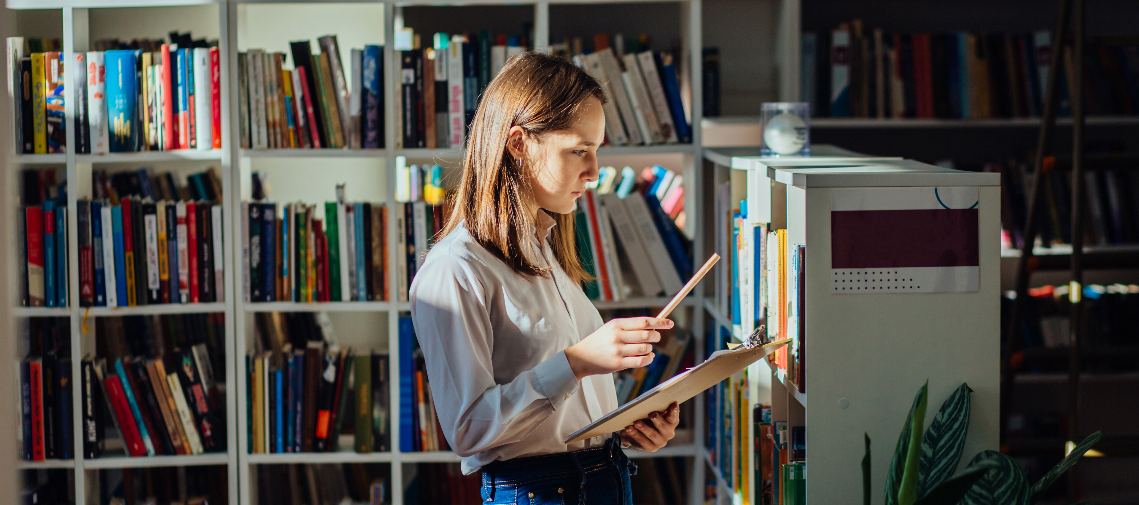  A girl looking for books in a library