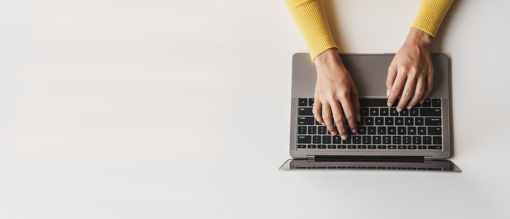 A decorative element: someone working on a laptop