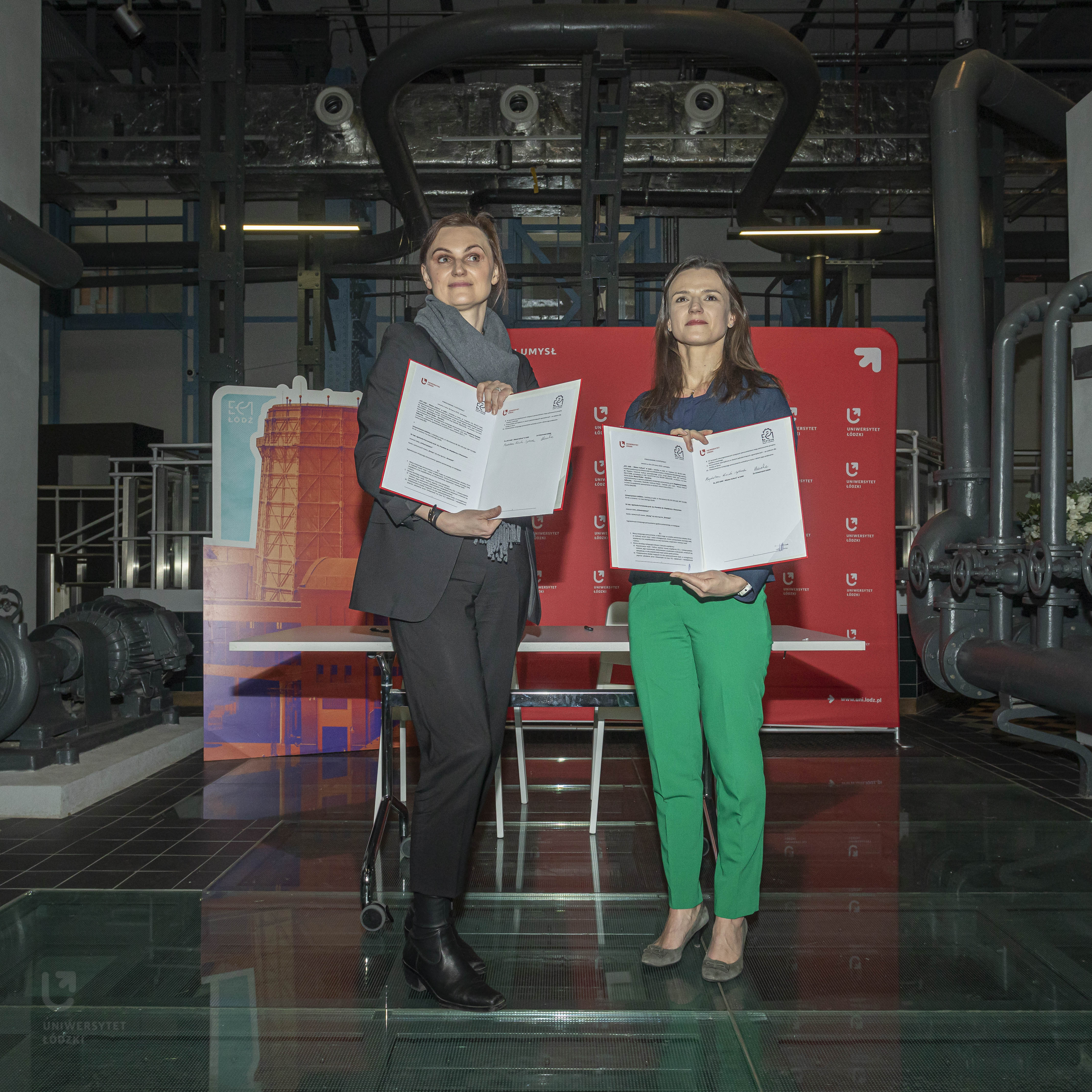 dwie kobiety z egzemplarzami podpisanego porozumienia